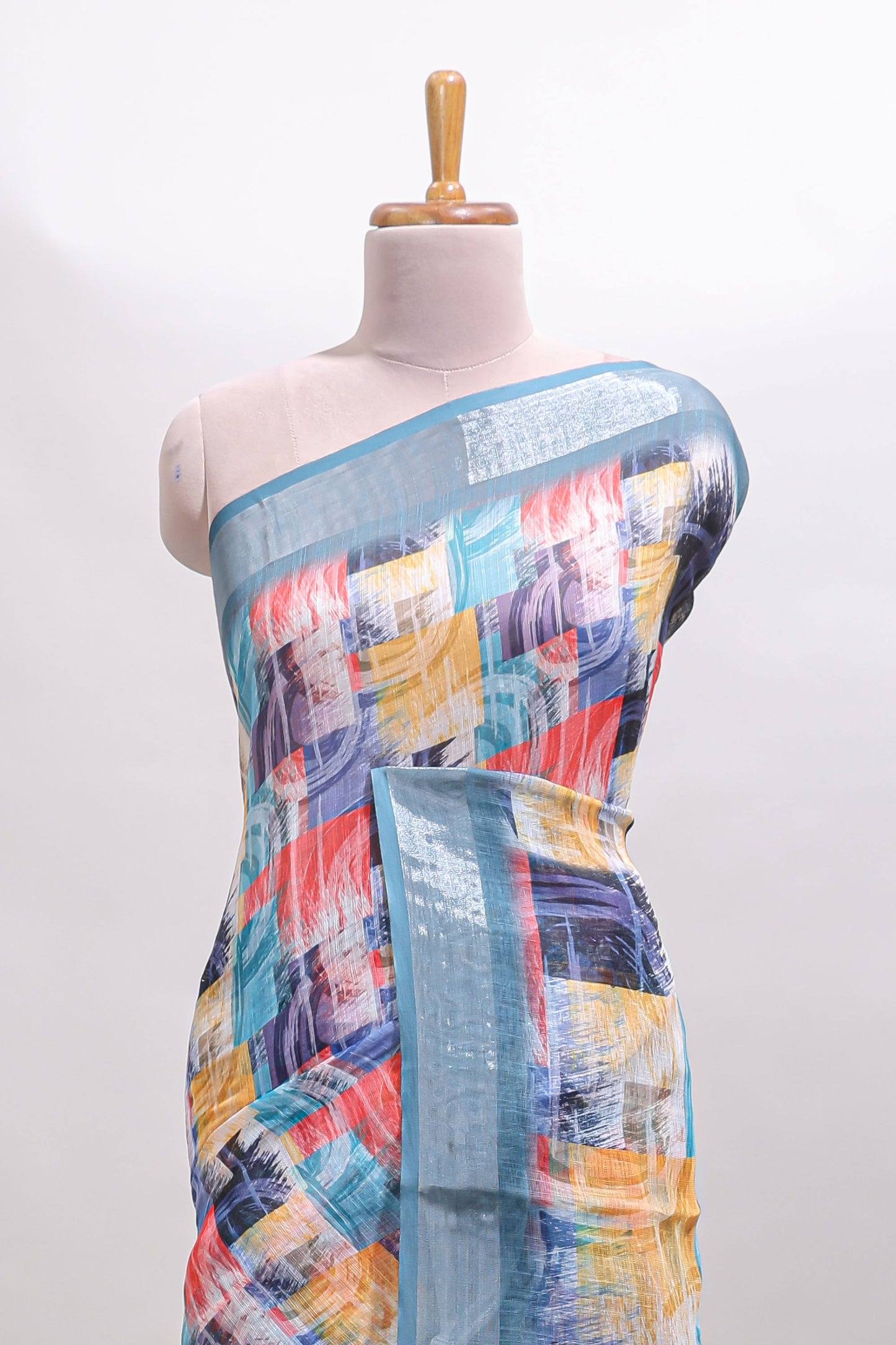 Multi color geometric design linen cotton saree with contrast zari border and matching blouse