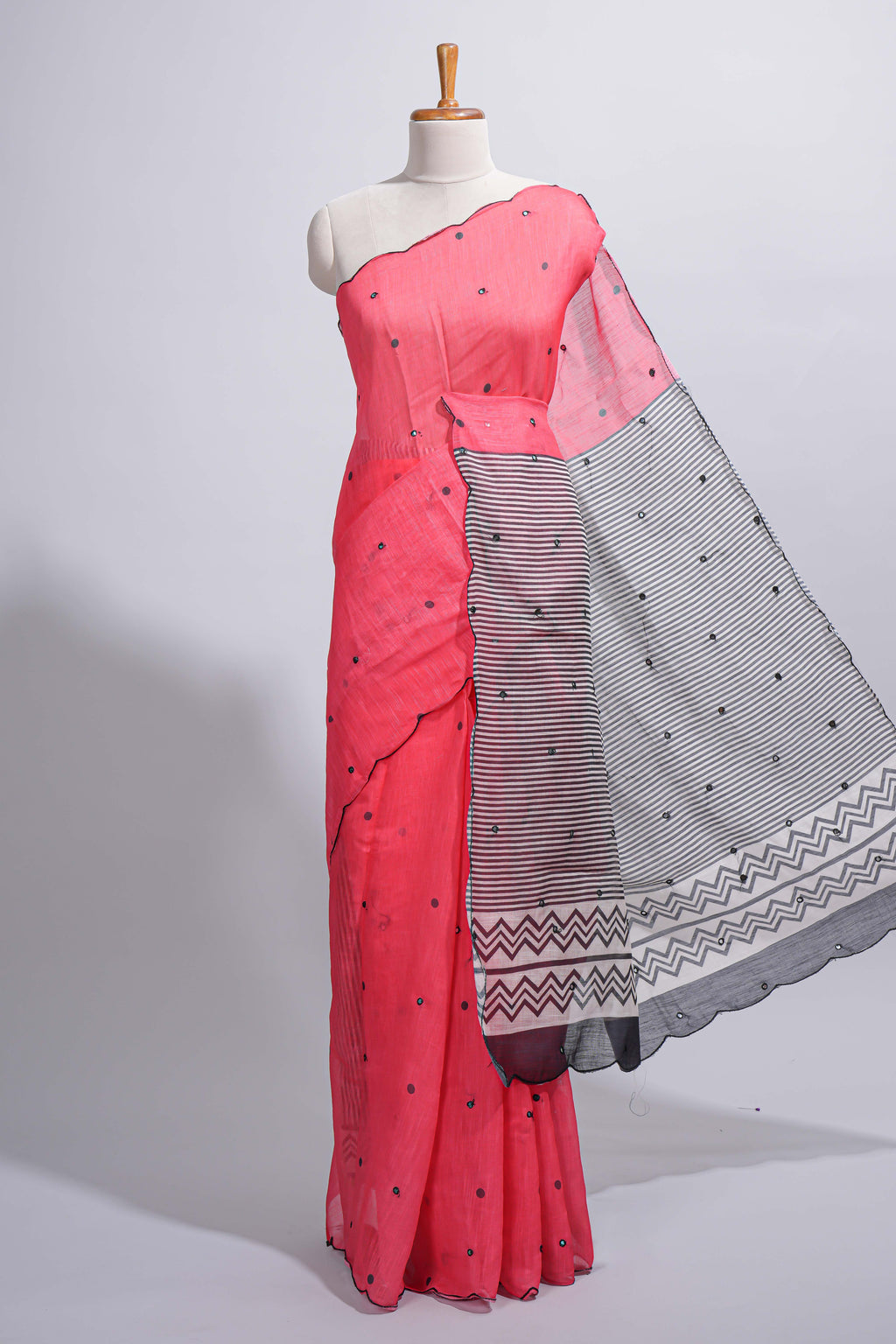 Coral pink linen cotton saree with  sequin details striped and geometric zigzag pallu with scallop border along with striped blouse