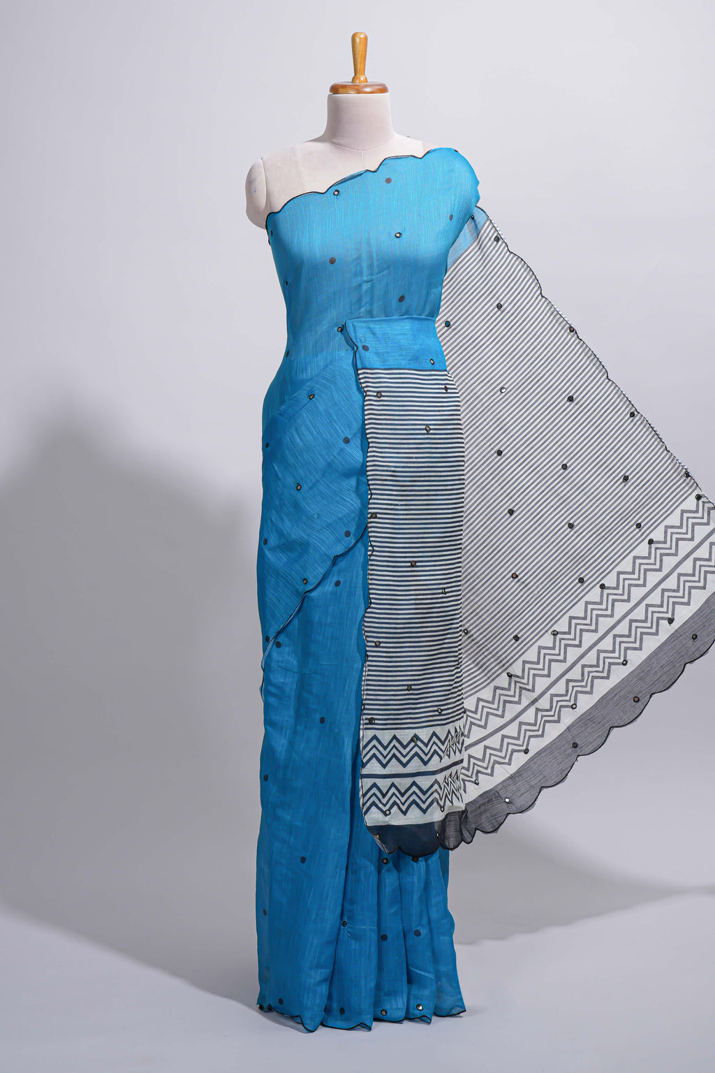 Blue linen cotton saree with  sequin details striped and geometric zigzag pallu with scallop border along with striped blouse