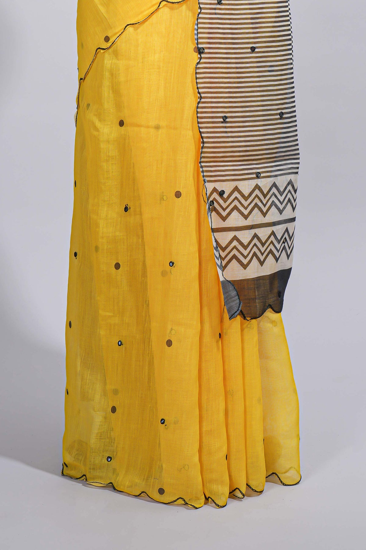 Yellow linen cotton saree with  sequin details striped and geometric zigzag pallu with scallop border along with striped blouse