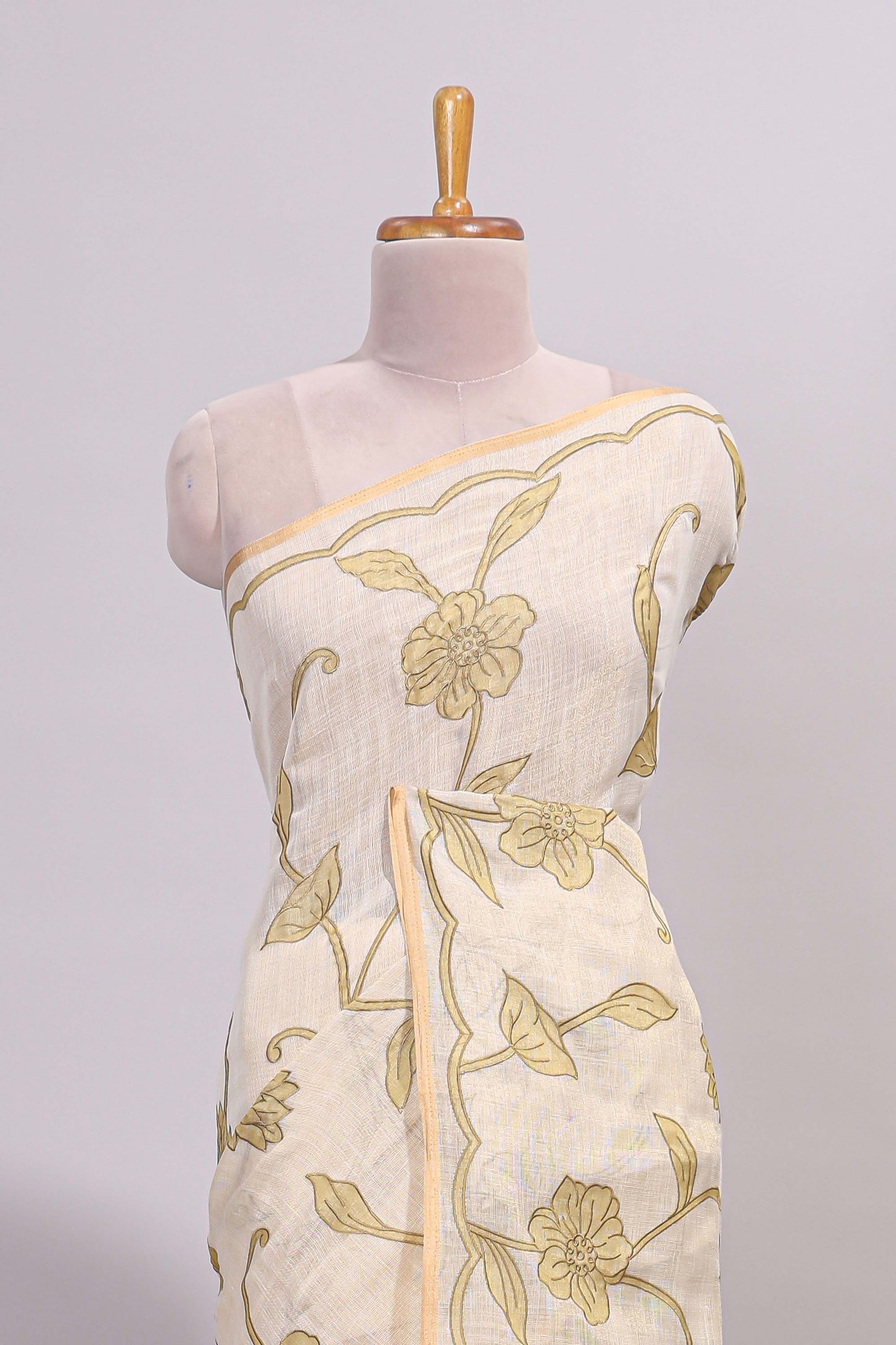 Cream floral design linen cotton saree with self zari border and matching printed blouse