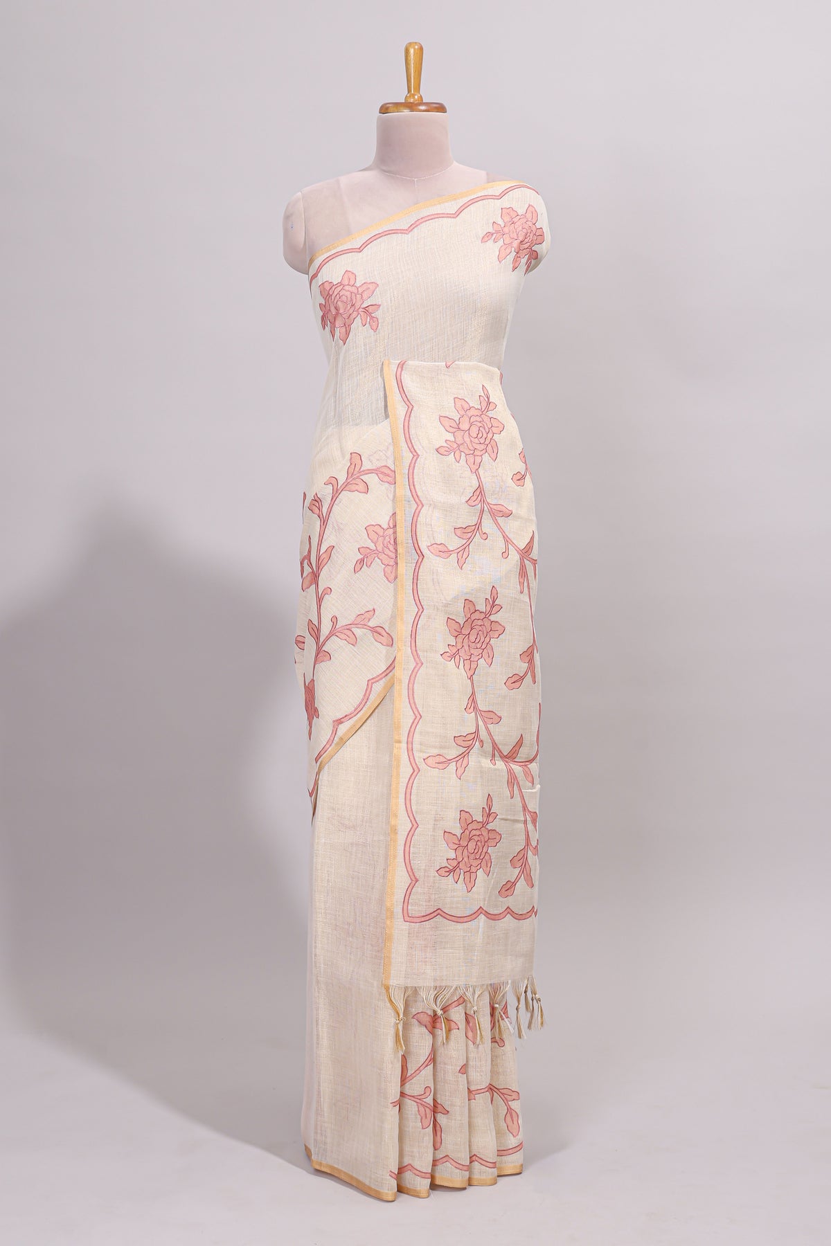 Cream floral design linen cotton saree with self zari border and contrast printed blouse