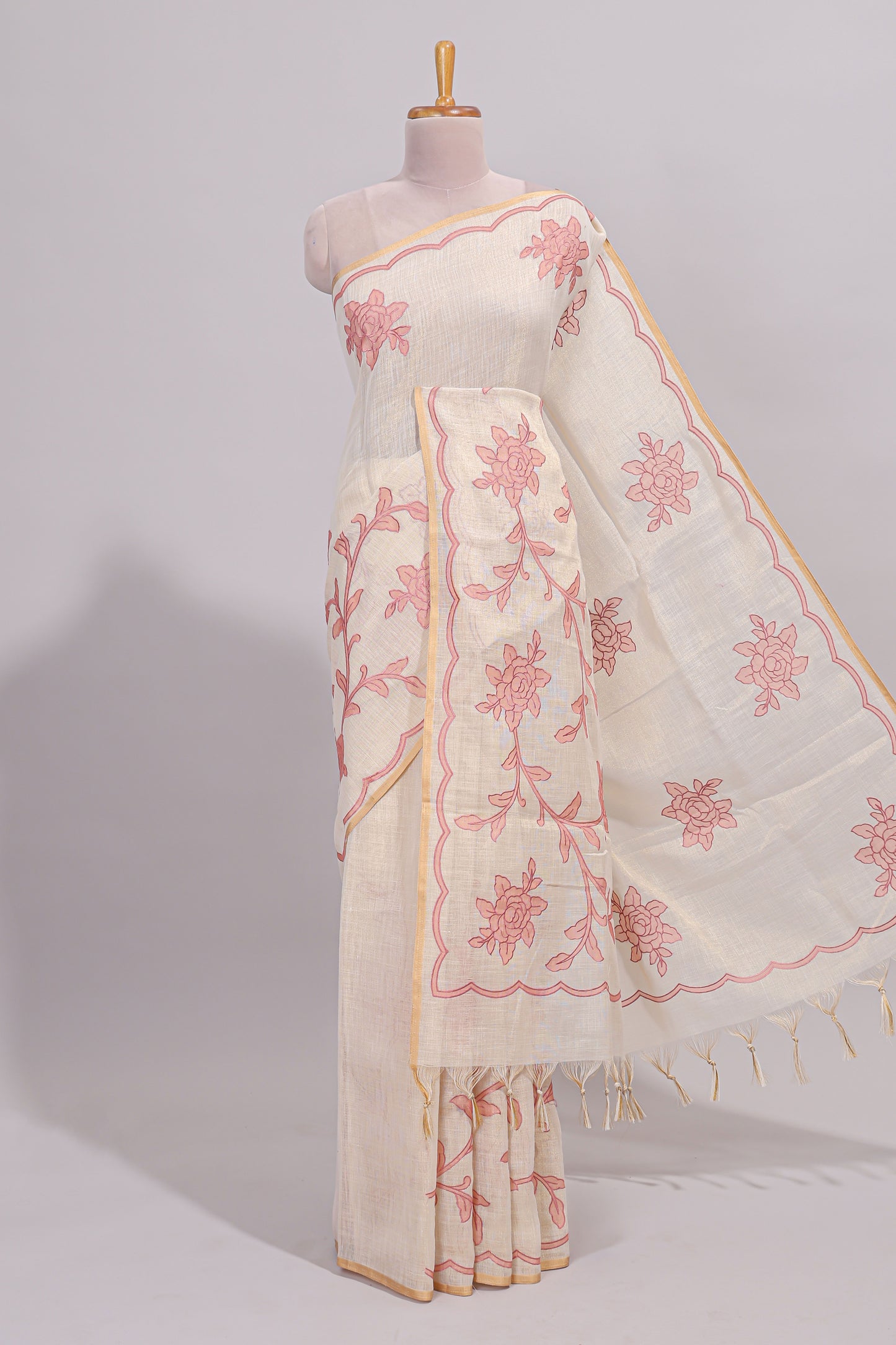 Cream floral design linen cotton saree with self zari border and contrast printed blouse