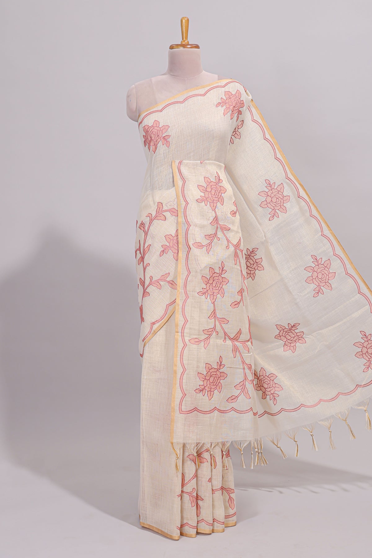Cream floral design linen cotton saree with self zari border and contrast printed blouse