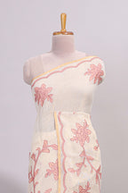 Cream floral design linen cotton saree with self zari border and contrast printed blouse