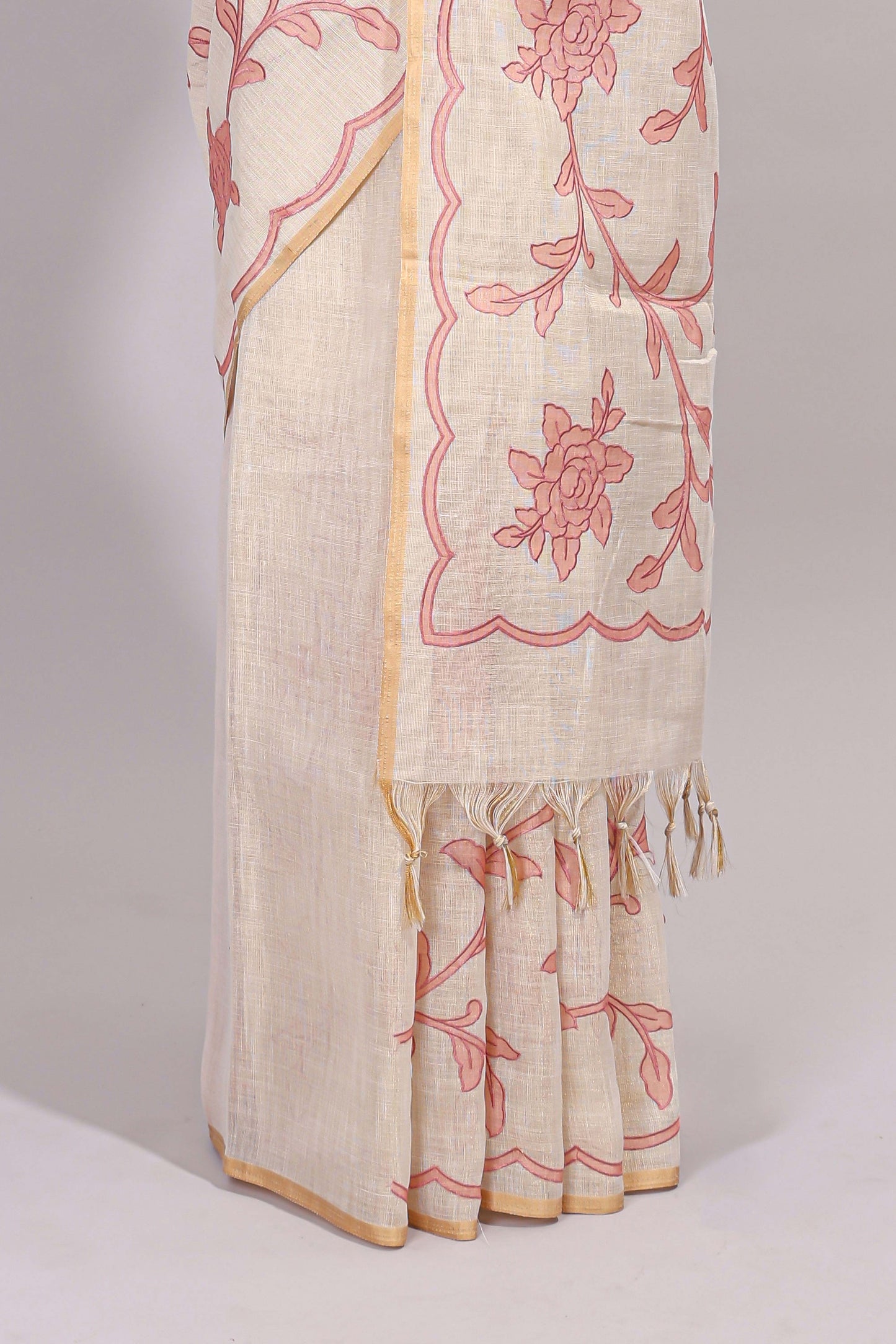 Cream floral design linen cotton saree with self zari border and contrast printed blouse