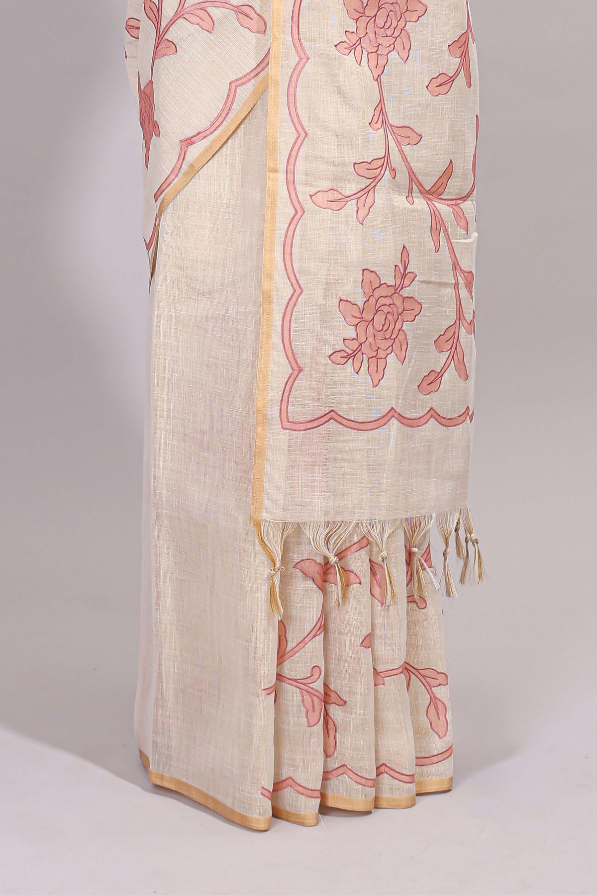 Cream floral design linen cotton saree with self zari border and contrast printed blouse