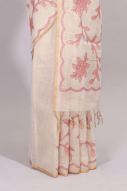Cream floral design linen cotton saree with self zari border and contrast printed blouse
