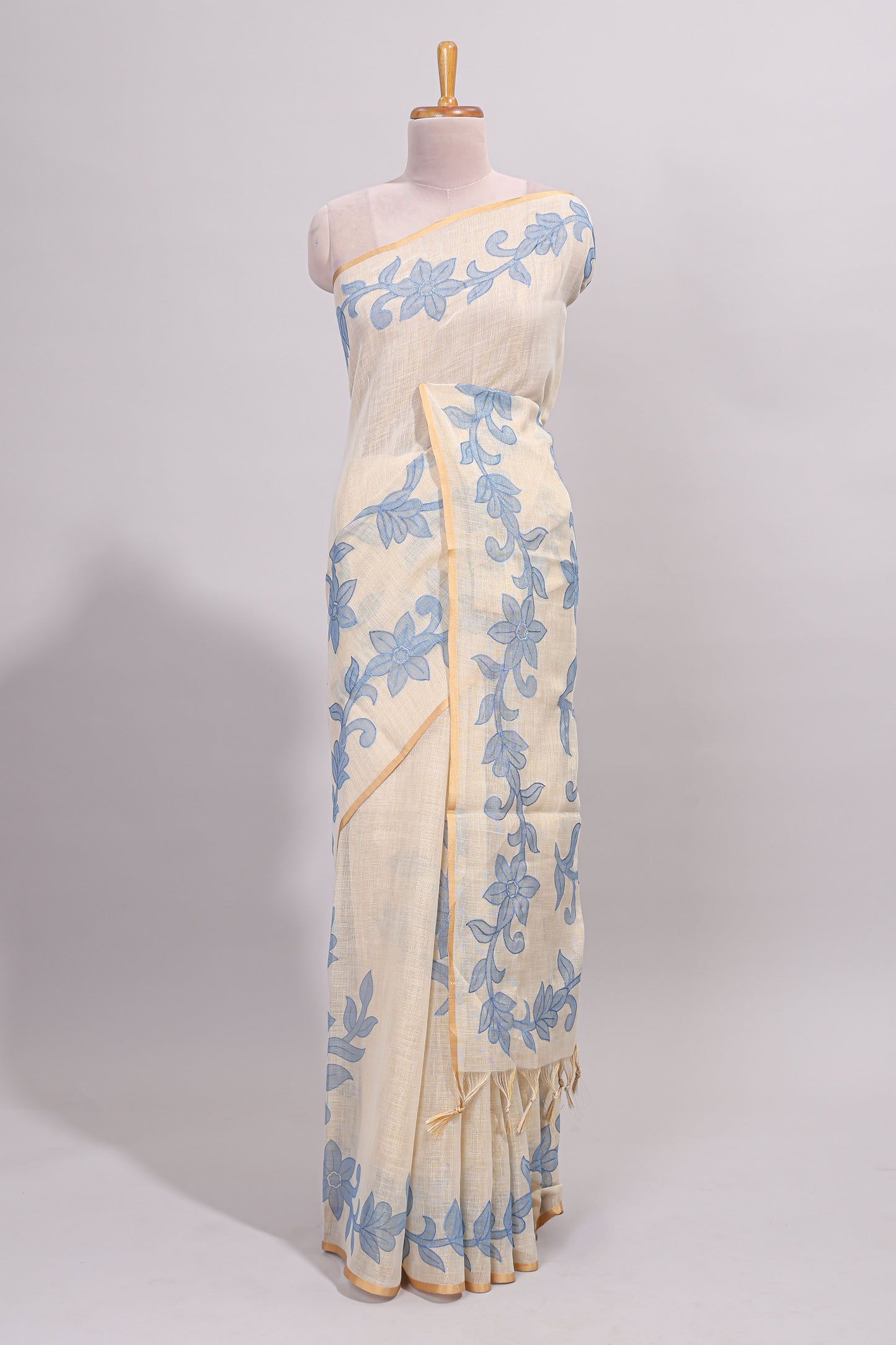 Cream floral design linen cotton saree with self zari border and matching printed blouse