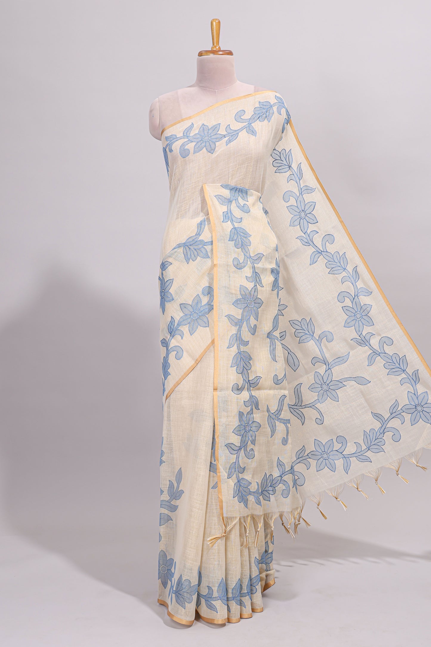Cream floral design linen cotton saree with self zari border and matching printed blouse