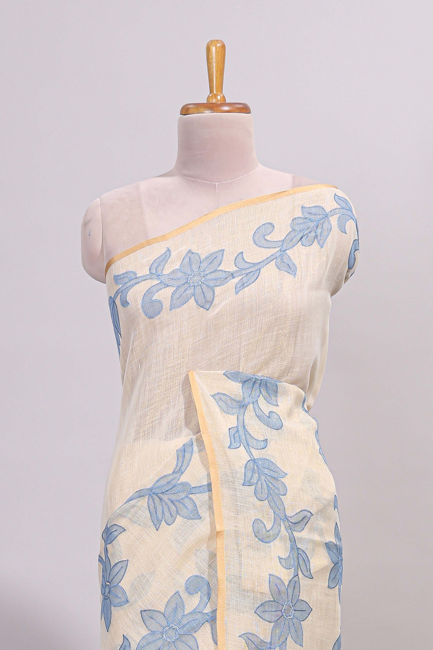 Cream floral design linen cotton saree with self zari border and matching printed blouse