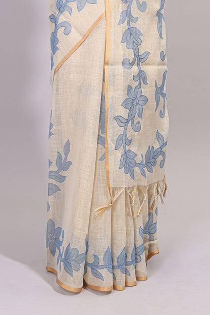 Cream floral design linen cotton saree with self zari border and matching printed blouse