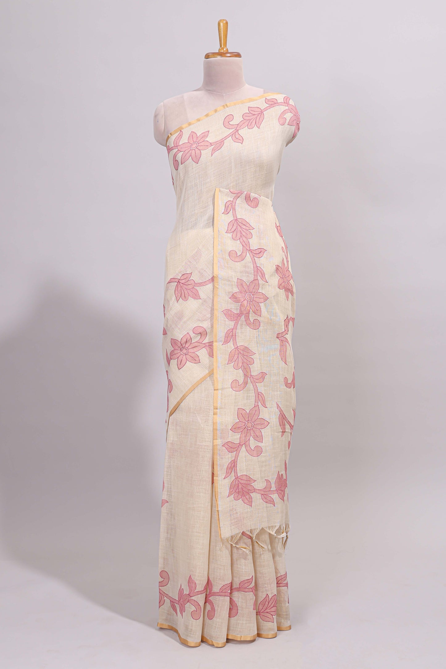 Cream floral design linen cotton saree with self zari border and matching printed blouse