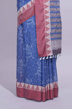 Blue linen small dotted elephant and floral motifs contrast border and printed pallu with geometric patterns and tassel detailing along with printed blouse