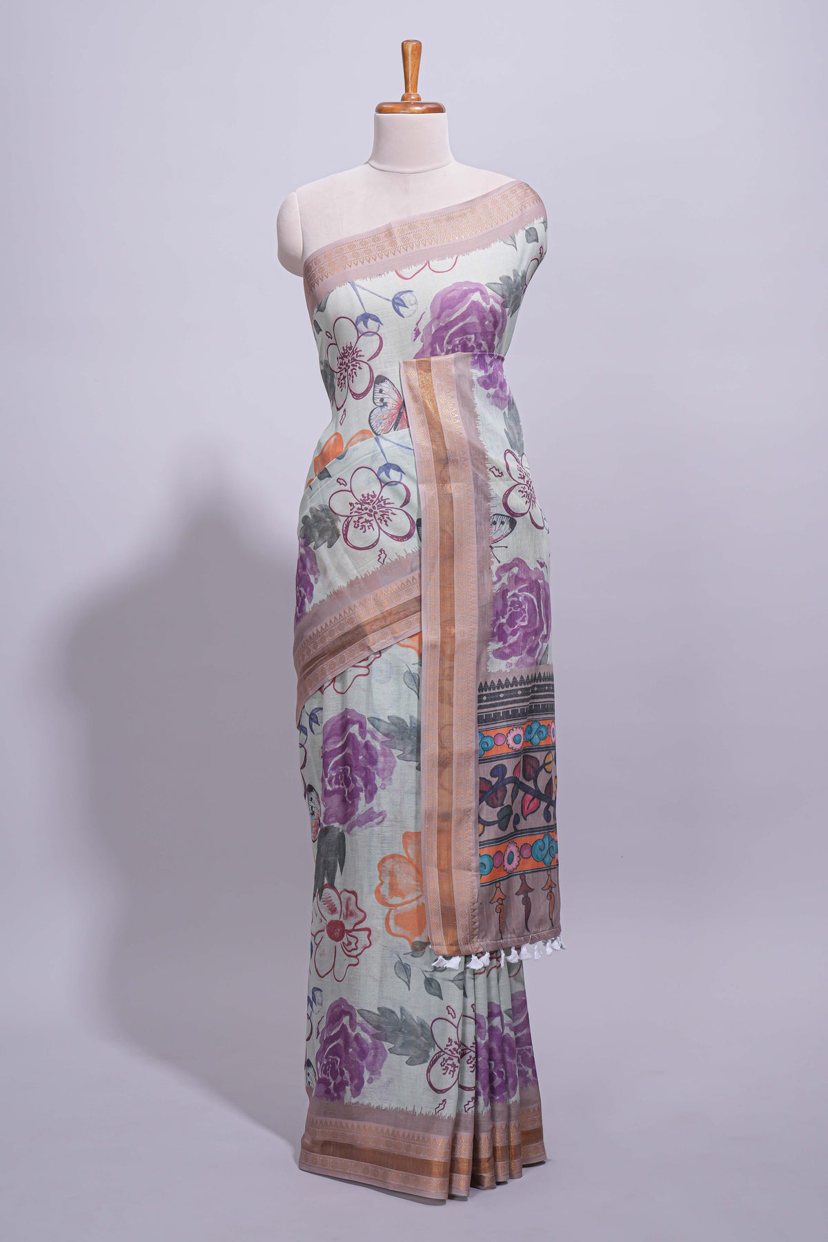 Ivory colour linen saree floral prints with pastel accents by a subtle gold zari border and printed pallu with tassel along with printed blouse