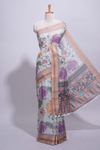 Ivory colour linen saree floral prints with pastel accents by a subtle gold zari border and printed pallu with tassel along with printed blouse