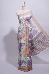 Ivory colour linen saree floral prints with pastel accents by a subtle gold zari border and printed pallu with tassel along with printed blouse