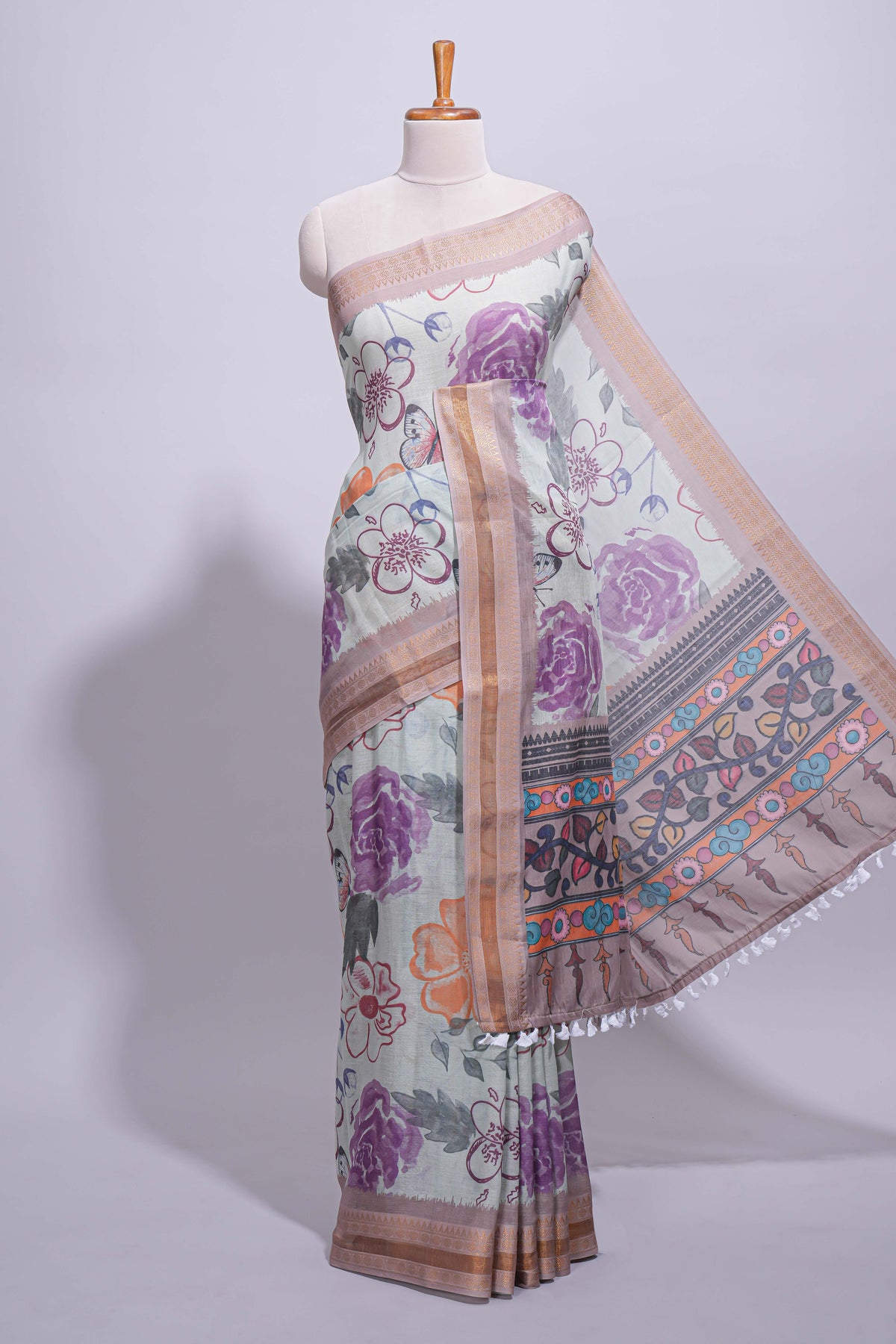 Ivory colour linen saree floral prints with pastel accents by a subtle gold zari border and printed pallu with tassel along with printed blouse