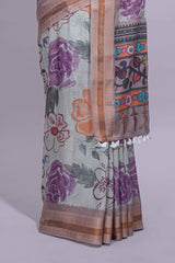 Ivory colour linen saree floral prints with pastel accents by a subtle gold zari border and printed pallu with tassel along with printed blouse