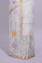 White linen saree delicate floral prints with pastel accents by a subtle gold zari border and  striped pallu with tassel  along with self blouse