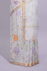 White linen saree delicate floral prints with pastel accents by a subtle gold zari border andstriped pallu with tasselalong with self blouse