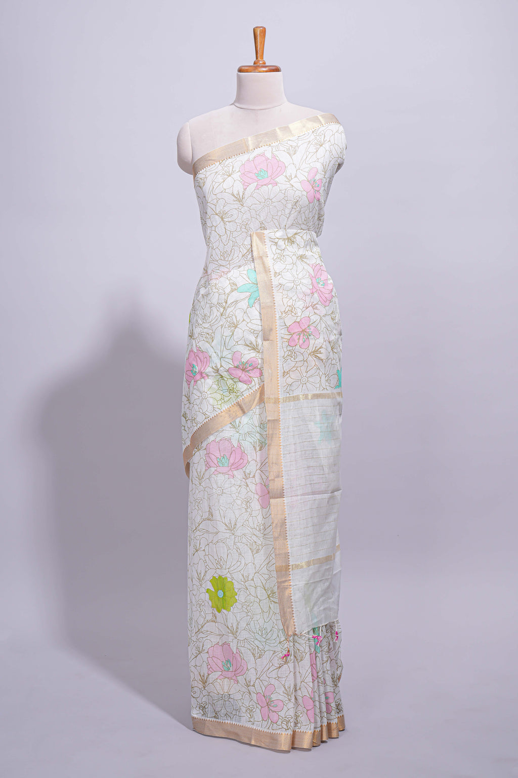 White linen saree floral prints with pastel accents by a subtle gold zari border and  striped pallu with tassel  along with self blouse