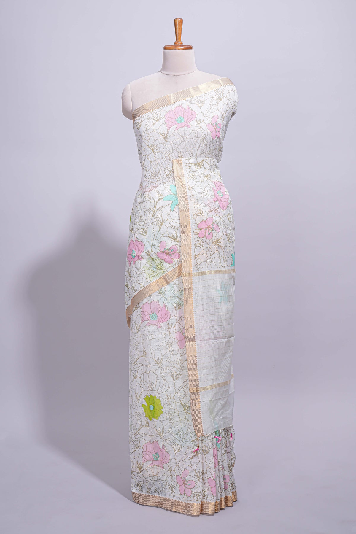 White linen saree floral prints with pastel accents by a subtle gold zari border and  striped pallu with tassel  along with self blouse