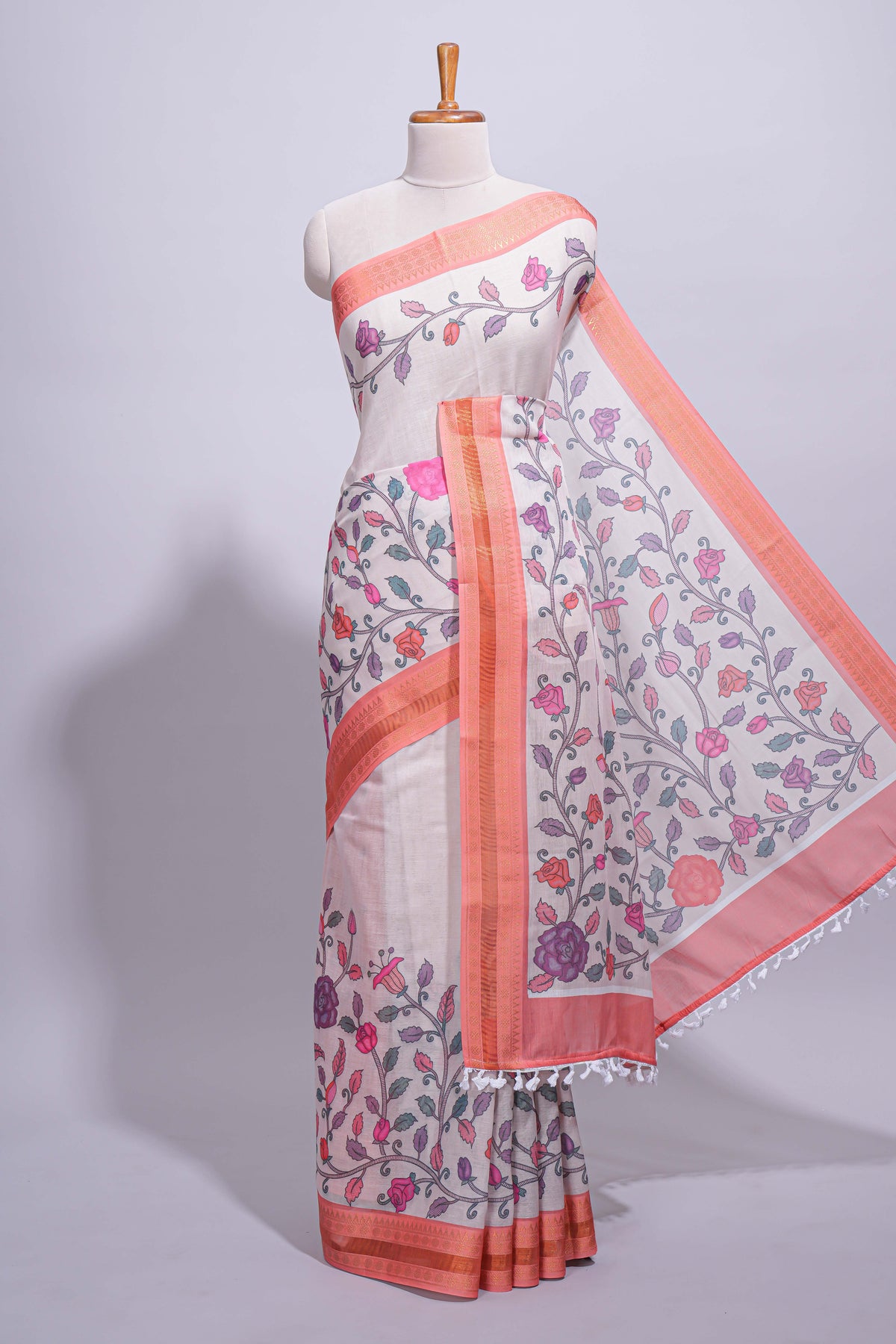Ivory with orange linen cotton saree with multicolour  floral vine print with a contrast border and printed pallu along with printed blouse