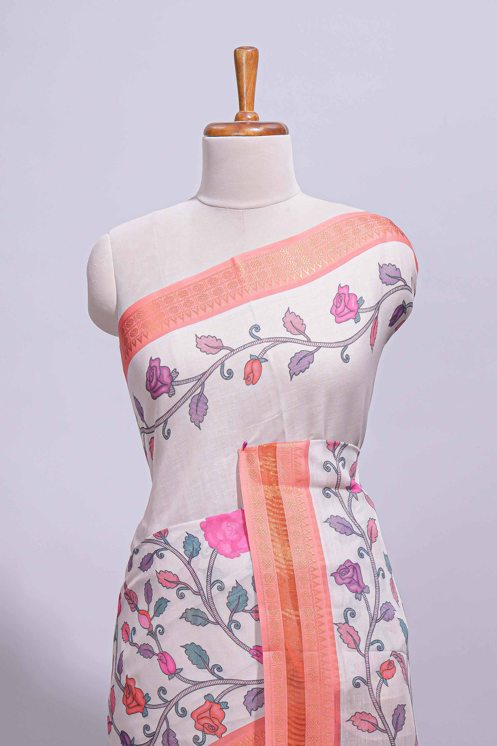 Ivory with orange linen cotton saree with multicolour  floral vine print with a contrast border and printed pallu along with printed blouse