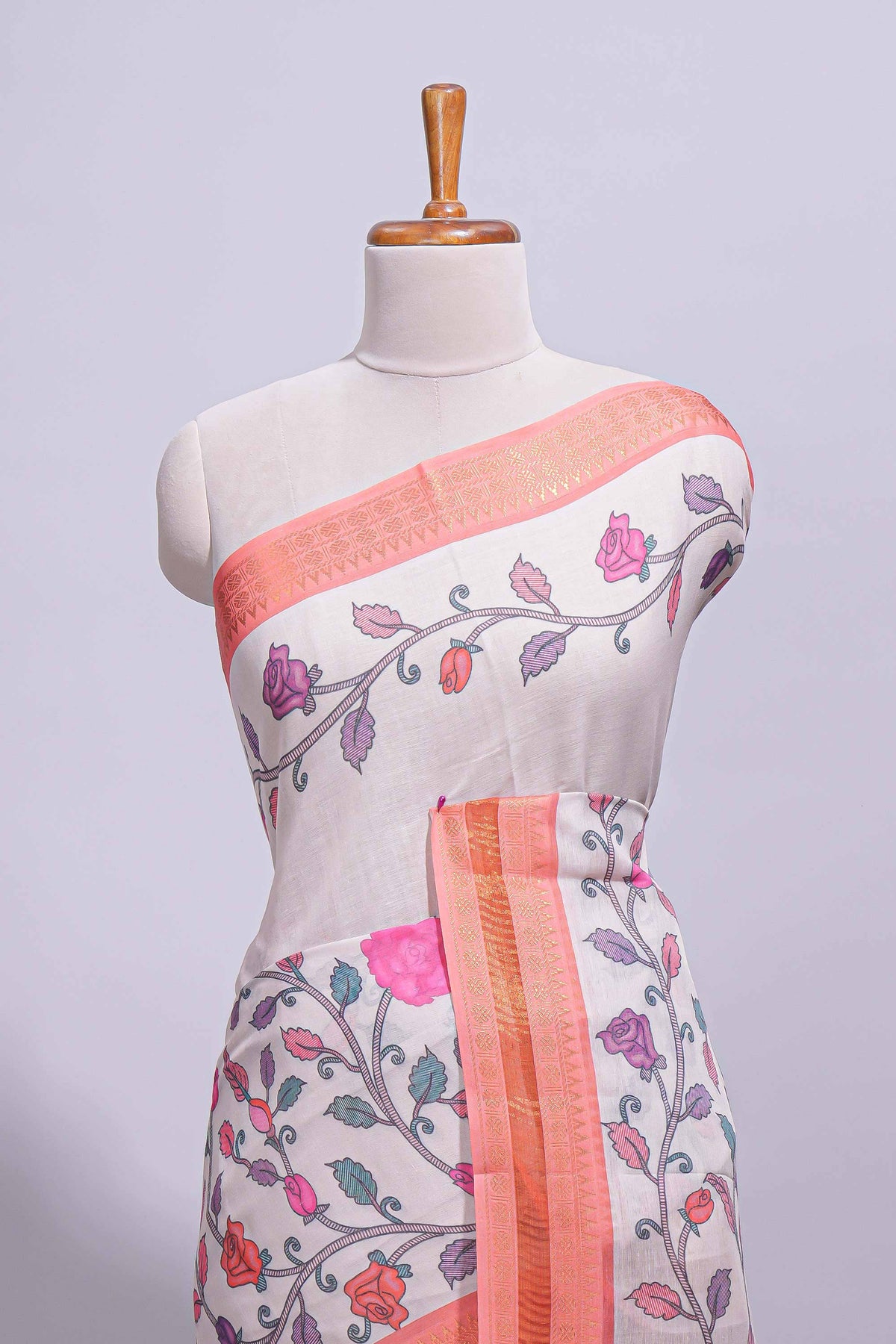 Ivory with orange linen cotton saree with multicolour  floral vine print with a contrast border and printed pallu along with printed blouse
