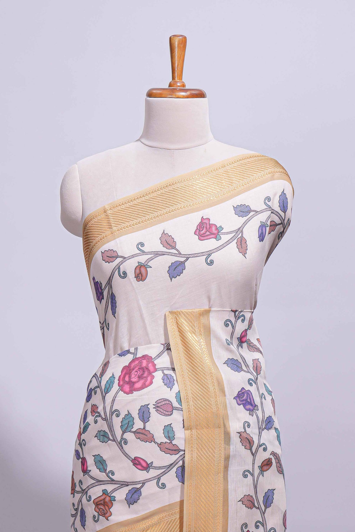 Ivory with yellow linen cotton saree with multicolour  floral vine print with a contrast border and printed pallu along with printed blouse