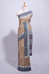 Brown linen small dotted elephant and floral motifs contrast border and printed pallu with geometric patterns and tassel detailing along with printed blouse