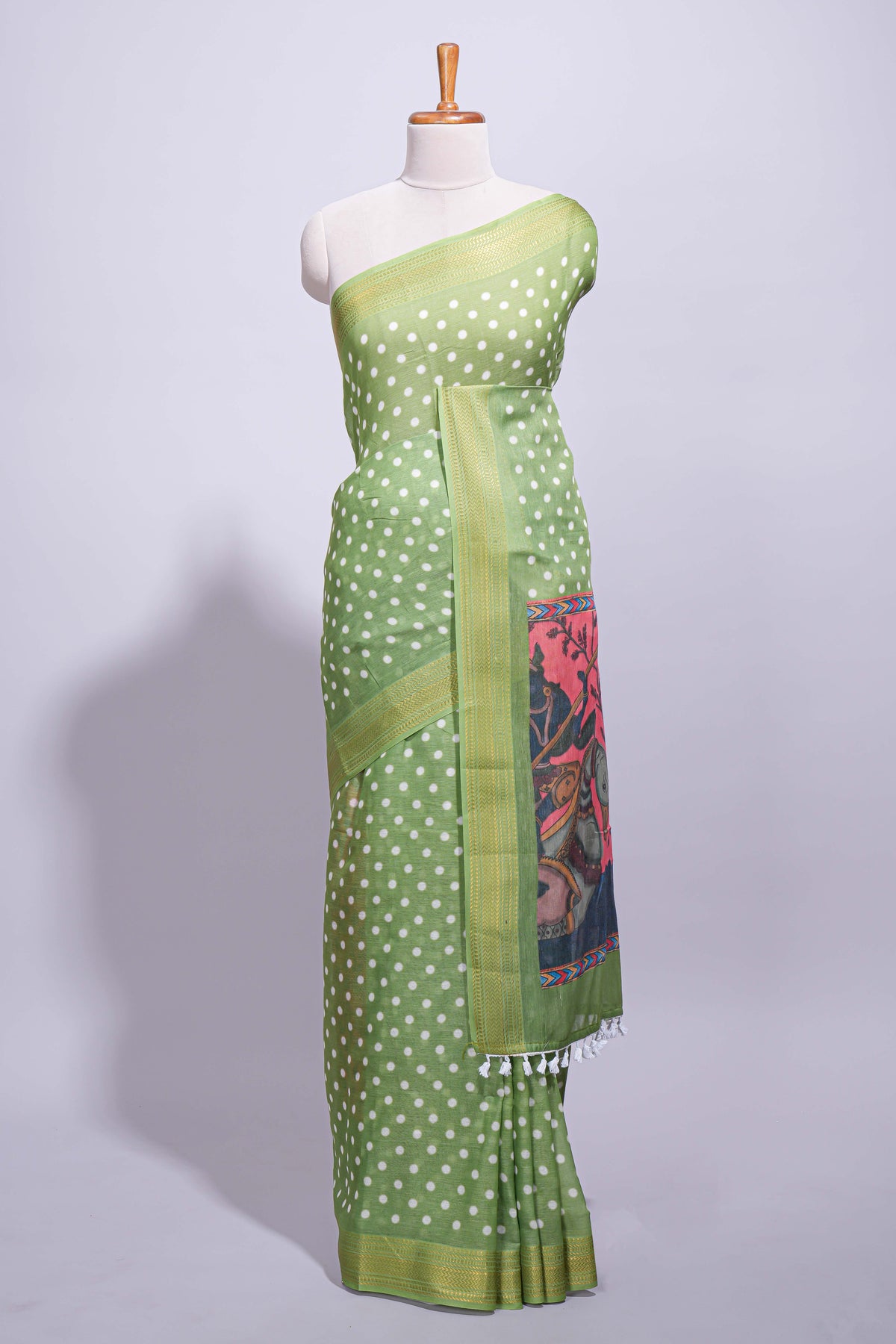 Green linen saree white polka dot pattern all over the body and self zari border with printed pallu along with printed blouse