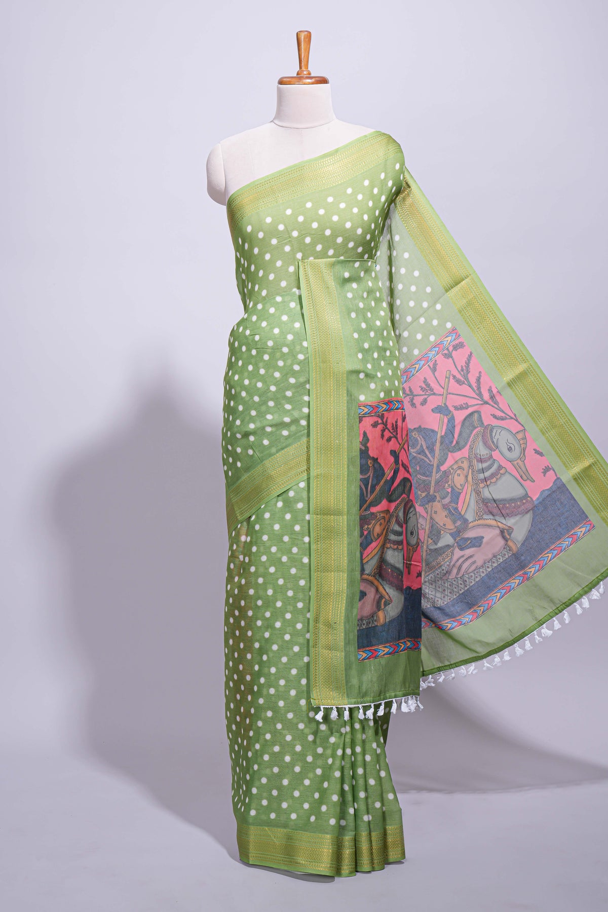 Green linen saree white polka dot pattern all over the body and self zari border with printed pallu along with printed blouse
