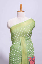 Green linen saree white polka dot pattern all over the body and self zari border with printed pallu along with printed blouse