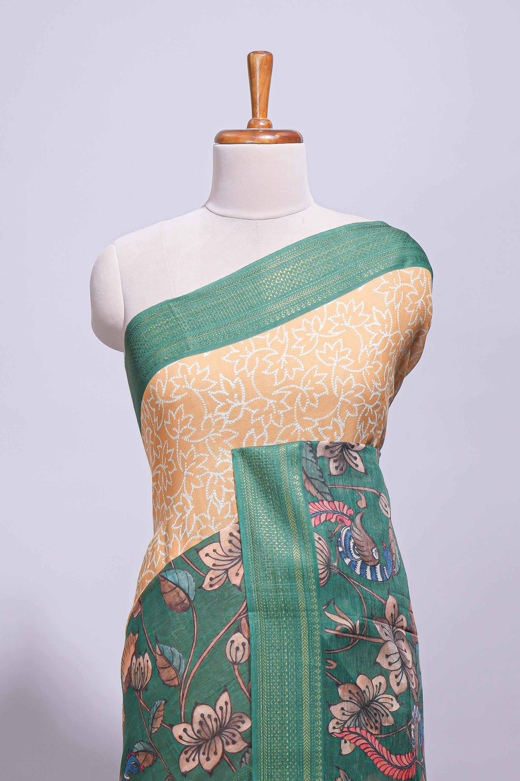 Linen saree with a mustard yellow and green  featuring floral patterns with a contrast  floral printed pallu and zari border with tassel