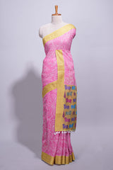 Pink linen saree with white dotted floral patterns with golden zari border and a multicolour pichwai motifs along with printed blouse