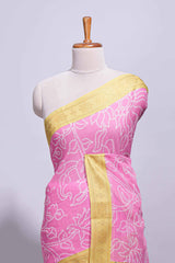 Pink linen saree with white dotted floral patterns with golden zari border and a multicolour pichwai motifs along with printed blouse