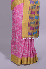 Pink linen saree with white dotted floral patterns with golden zari border and a multicolour pichwai motifs along with printed blouse