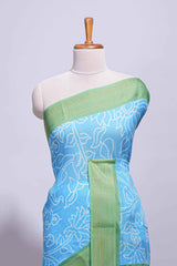 Blue linen saree with white dotted floral patterns with golden zari border and a multicolour pichwai motifs along with printed blouse