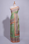 Soft green linen saree with floral print highlighted with afloral pallu and zari border along with contrast blouse piece