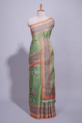 Soft green linen saree with floral print highlighted with afloral pallu and zari border along with contrast blouse piece