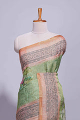 Soft green linen saree with floral print highlighted with afloral pallu and zari border along with contrast blouse piece