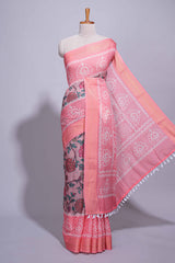 Linen saree with a pink colourfeaturing floral patterns with a contrastfloral printed pallu and zari border with tassel along with contrast blouse