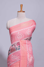 Linen saree with a pink colour  featuring floral patterns with a contrast  floral printed pallu and zari border with tassel along with contrast blouse