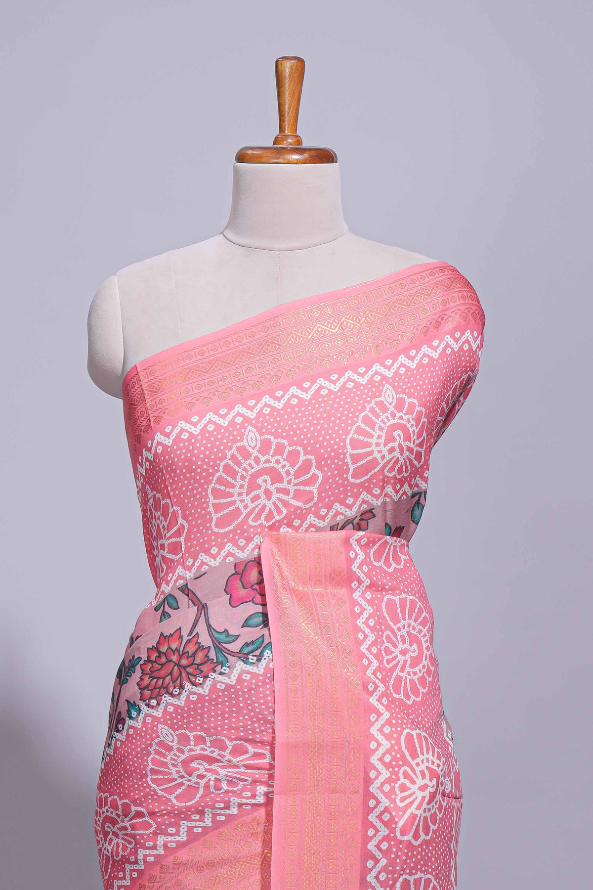 Linen saree with a pink colour  featuring floral patterns with a contrast  floral printed pallu and zari border with tassel along with contrast blouse