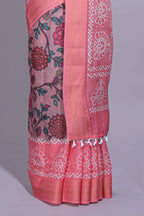 Linen saree with a pink colour  featuring floral patterns with a contrast  floral printed pallu and zari border with tassel along with contrast blouse