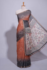 Elegant rust and charcoal linen saree with geometric dotted motifs paired with a floral printed pallu and contrast border with tassel along with printed blouse