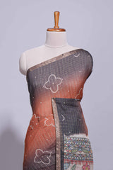 Elegant rust and charcoal linen saree with geometric dotted motifs paired with a floral printed pallu and contrast border with tassel along with printed blouse