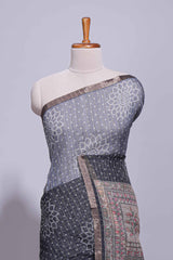 Elegant black and charcoal linen saree with geometric dotted motifs paired with a floral printed pallu and contrast border with tassel along with printed blouse